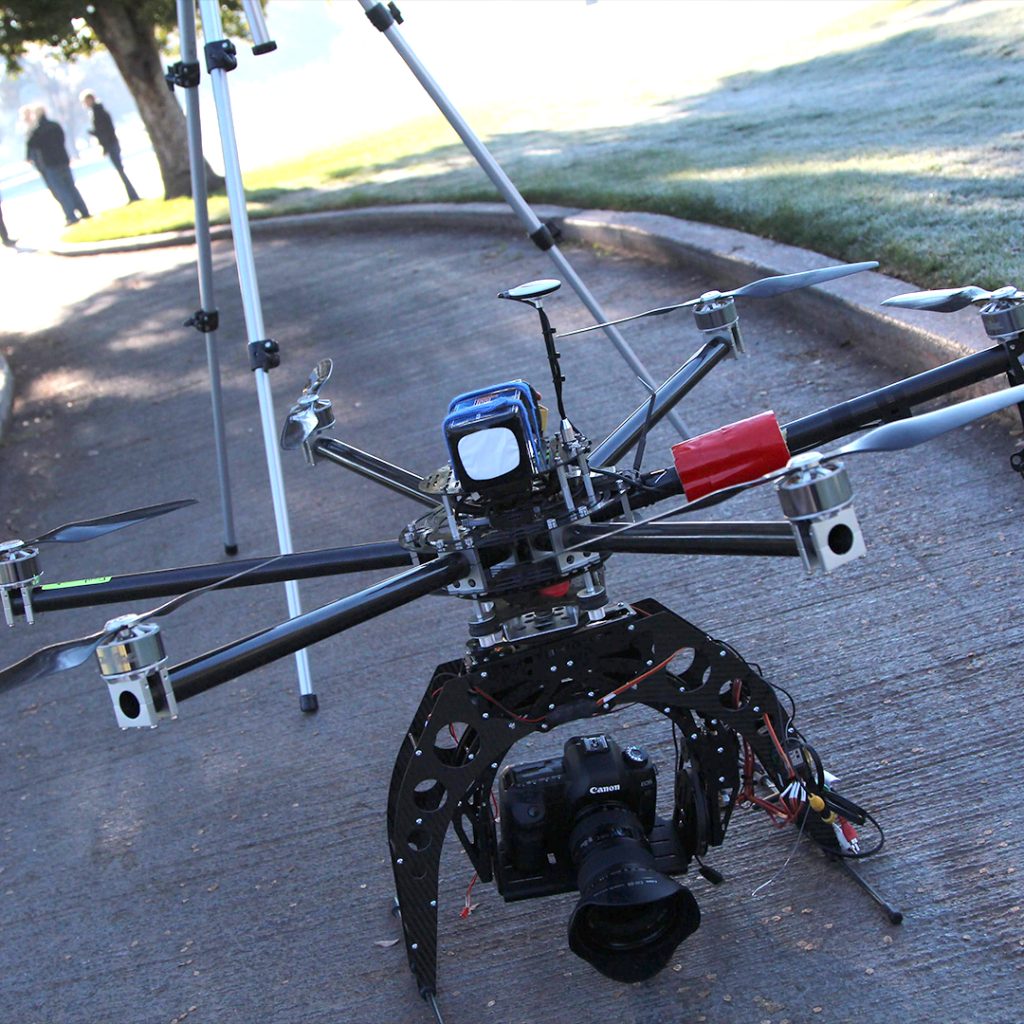Camera drone ready for takeoff on a farm