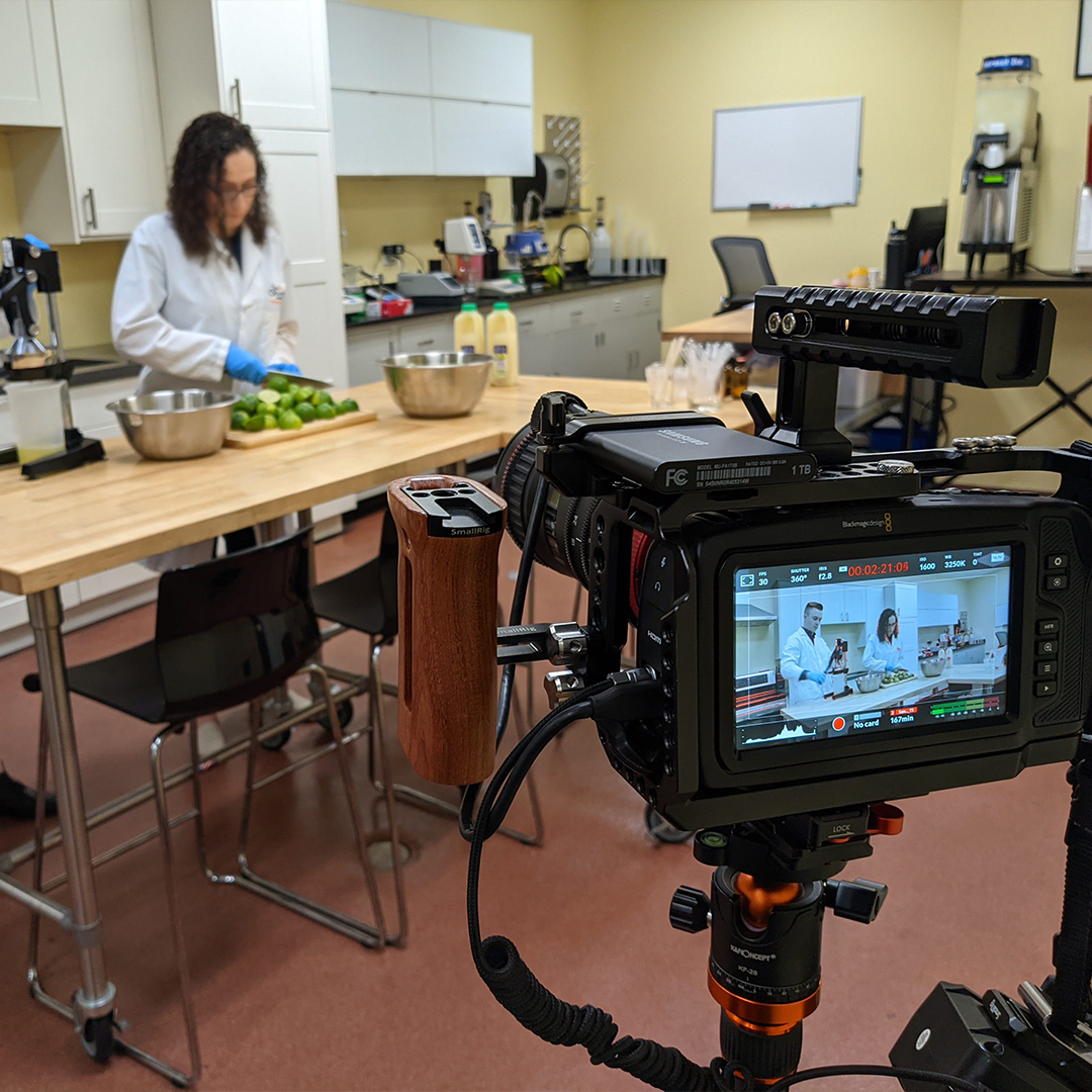 Camera filming a food safety lab technician for a training video